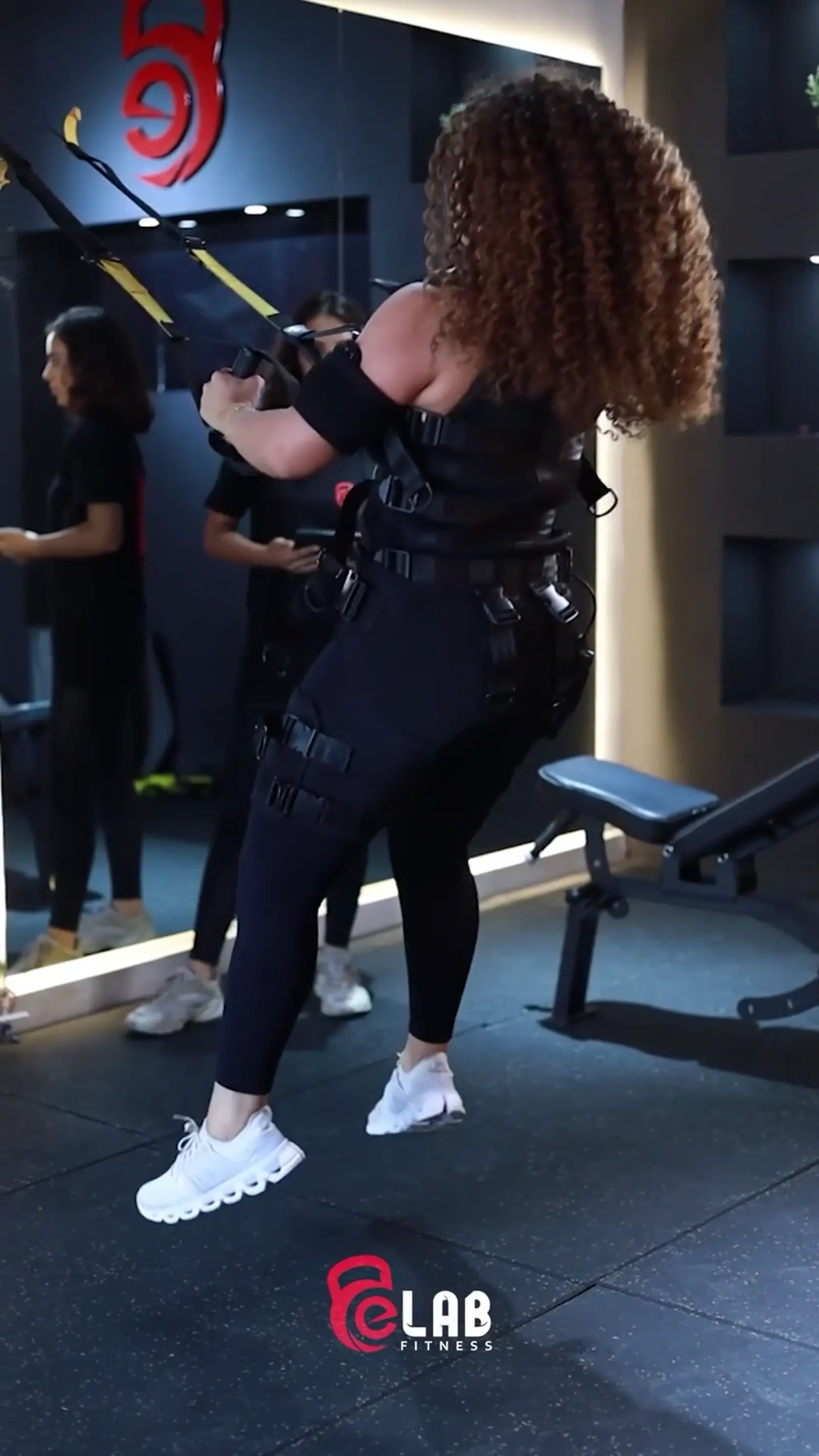 Model holding a branded water bottle during an ad shoot